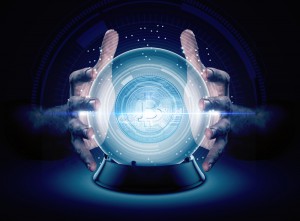 A pair of male hands surrounding a crystal ball conjuring up a bitcoin crytocurrency hologram on an isolated dark studio background
