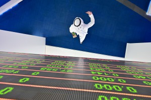 A trader walks by beneath a stock display board at the Dubai Stock Exchange in the United Arab Emirates, on March 8 as Saudi's stock exchange fell 6.5 percent and other Gulf markets tumbled to multi-year lows. GIUSEPPE CACACE/AFP via Getty Images
